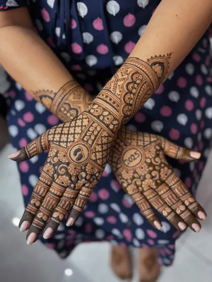 A slightly different pose, highlighting the beautiful flow of the baby shower henna design.
