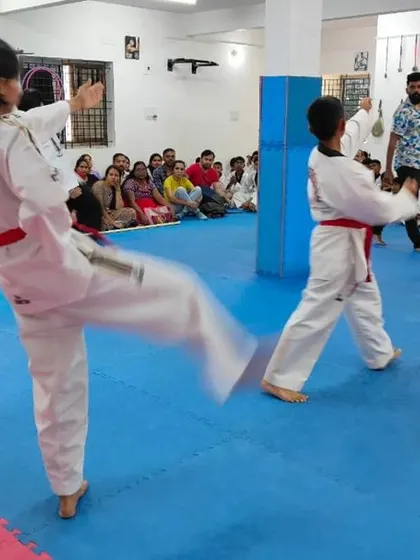 A student executes a powerful kick during her form.