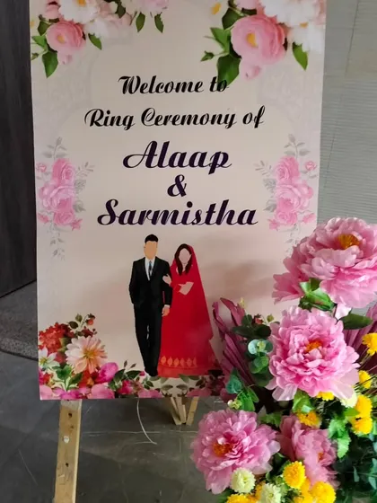 A personalized welcome sign for a ring ceremony. We design custom easel signs with the couple's names and illustrations, which we pair with a beautiful floral arrangement to greet guests as they arrive.