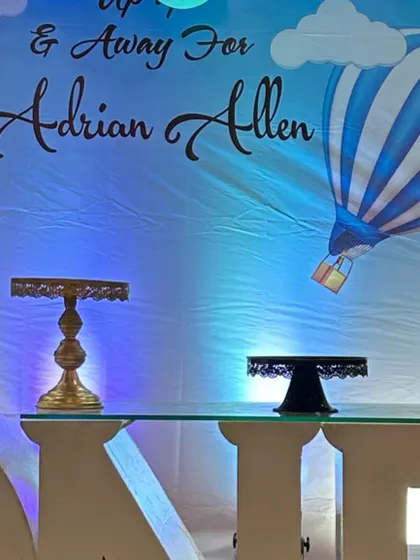 A personalized backdrop for a hot air balloon themed first birthday, featuring the child's name and "Up, Up & Away" text.
