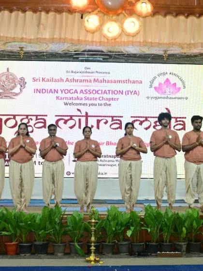 Our students in a namaskar pose at the start of their demonstration at the Yoga Mitra Mela. This gesture of respect sets the tone for a practice rooted in humility and devotion.