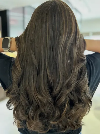 A cool and beautifully blended classic highlight technique. The three-tone color adds incredible depth, and the long layers haircut provides movement and style.