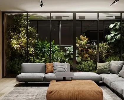 We transformed this living room by installing a floor-to-ceiling glass-enclosed garden. This lush installation acts as a living wall, providing a constant view of vibrant greenery while separating the space with style.