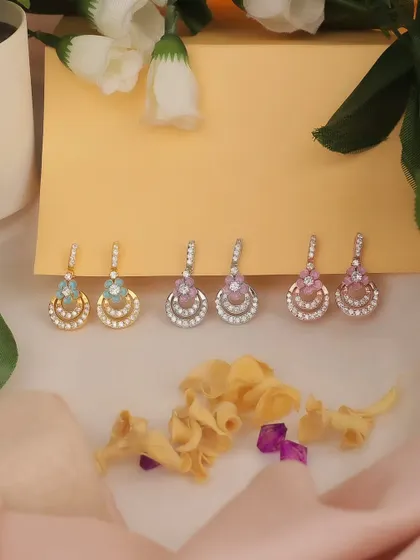A colorful display of custom jewelry earrings for an e-commerce photoshoot. The soft lighting and pastel background create a cheerful and inviting product image.