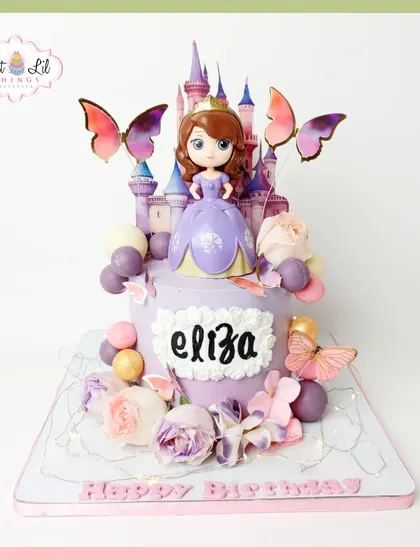 A fairytale cake for a little princess. This Sofia the First creation features a castle topper, beautiful butterflies, and floral details in a lovely lavender palette, perfect for a magical birthday.