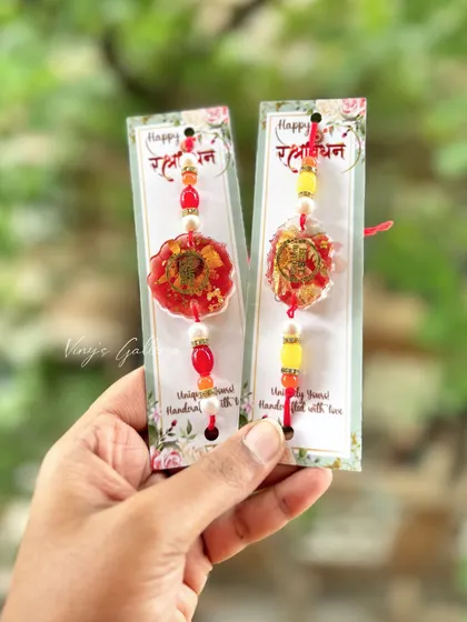 These Ganesha-themed resin rakhis are a beautiful way to celebrate your bond. The vibrant red and yellow colors, combined with the divine motif, make for a truly special rakhi.