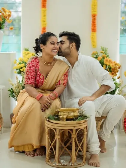 A quiet, happy moment between the couple during their Haldi ceremony, showing that even in the midst of celebration, there are personal connections.