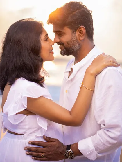 A close-up filled with warmth and affection, perfectly capturing the love between the couple during their golden hour beach shoot.