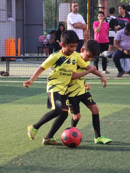 The heart of our academy is on the training ground. Here, two of our young players are locked in a friendly but focused duel for the ball, showcasing the passion and competitive spirit we nurture.
