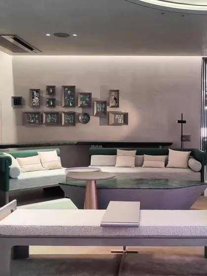 A wide view of the commercial space featuring the collection of framed abstract paintings, showing how they are integrated into the interior design.