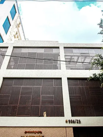 A wider view of the Vijaynagar renovation, showing the full extent of the new facade and how it creates a bold, contemporary statement in the neighborhood.