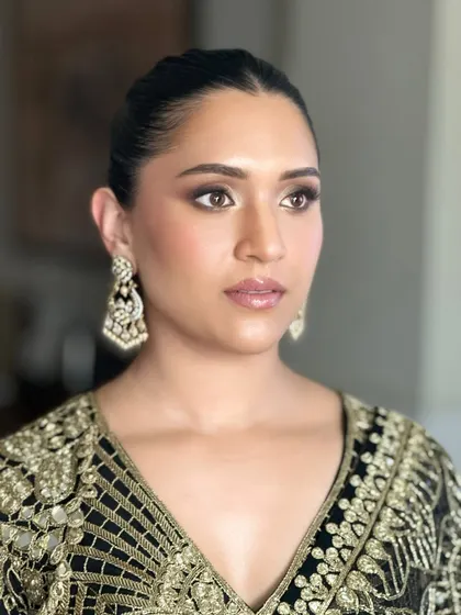 A close-up of Shanel's makeup. The smokey eye is blended to perfection, and her skin has a soft, matte finish that looks incredibly chic.