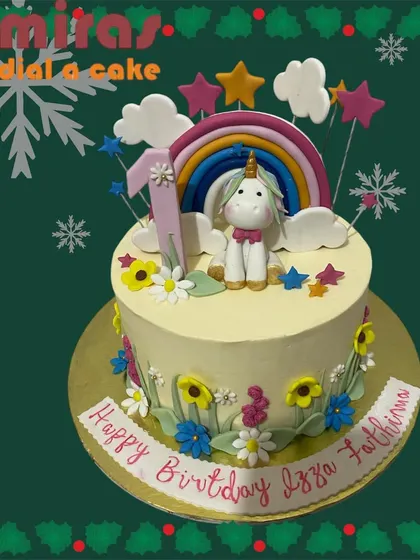 A magical unicorn cake for a first birthday celebration. This design features a cute unicorn sitting under a rainbow, surrounded by flowers and stars for a whimsical and sweet theme.