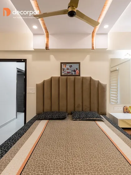 A cozy and comfortable bedroom featuring a custom upholstered headboard with a unique scalloped shape. The design is simple, elegant, and perfect for a restful night's sleep.
