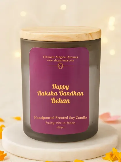 The 'Happy Raksha Bandhan Behan' candle in a frosted jar with a wooden lid. This one has a fruity, citrus, and fresh fragrance.