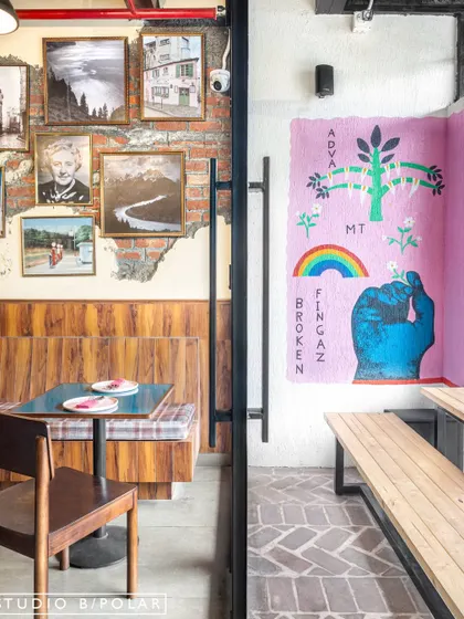 At Melthouse, we exposed and celebrated different textures, like the rustic brick wall and herringbone-patterned floor. These lived-in finishes, paired with eclectic art, make the space feel authentic and full of character.