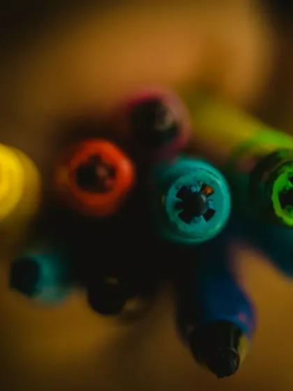 The tips of colored pens, shot with a very shallow depth of field. This technique transforms a simple subject into a beautiful abstract composition of color and light.
