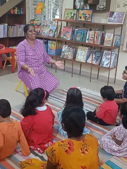 The storyteller's expressive face and open posture invite the children to join in the fun.