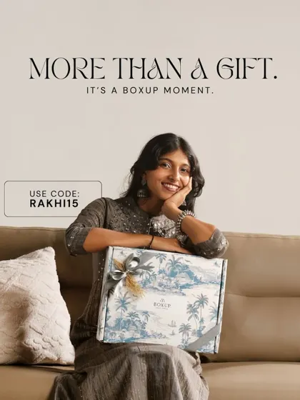 More than a gift, it's a BoxUp moment. A sister smiles, delighted with her beautiful Rakhi hamper, a memory worth creating and remembering.