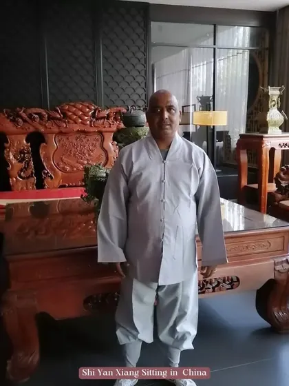 Dressed in traditional robes in China. This attire represents my identity as a secular disciple and my commitment to upholding the values of the Shaolin Temple.