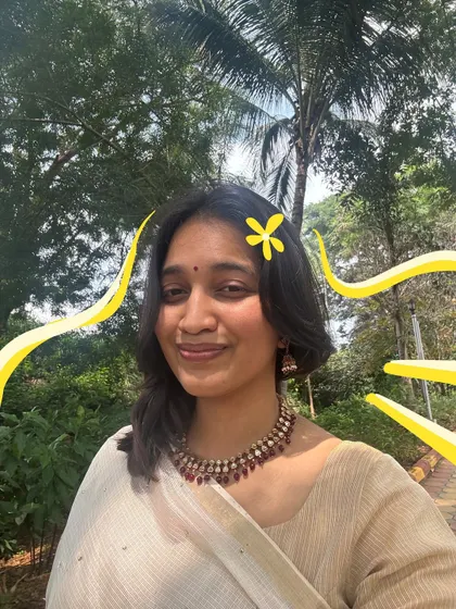 A happy selfie in my Onam saree. The yellow flower and squiggles I added make the photo feel even more cheerful.