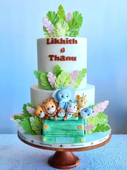 A full view of the safari wedding cake on its stand, giving a sense of its elegant presentation.