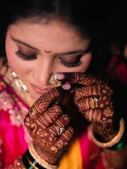 Another beautiful detail shot focusing on the eye makeup, lashes, and intricate henna design.
