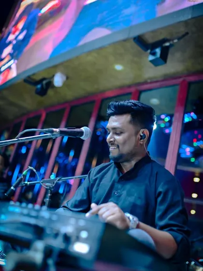 Our keyboardist, smiling as he adds rich harmonies and textures to our sound. He is a key part of our modern fusion arrangements.