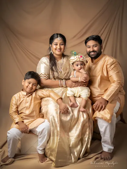 Another beautiful family celebrating with a Krishna theme. The two brothers, both dressed in traditional outfits, look absolutely adorable with their proud parents.