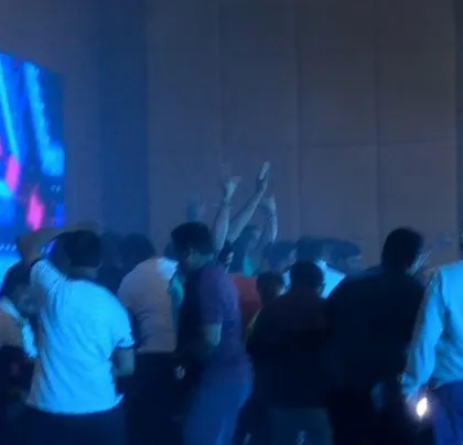 The party gets going with blue lighting and smoke.