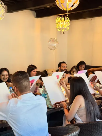 Guests getting into the creative zone at a birthday party. We love seeing everyone relax and enjoy the process of painting, no matter their skill level.