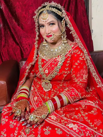 A confident and beautiful bride looking directly at the camera, showcasing her complete look from head to toe.