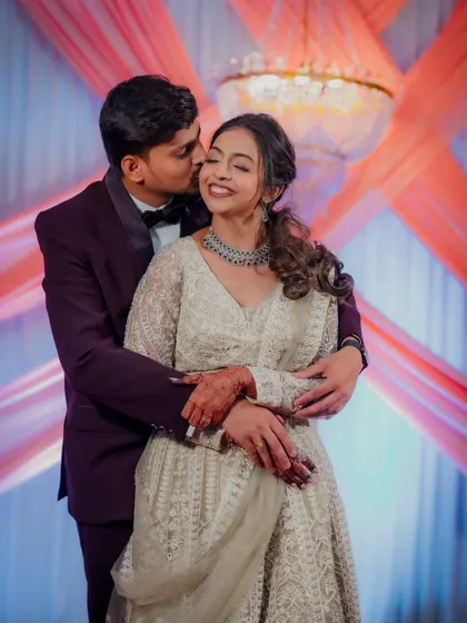Engagement ceremonies are full of beautiful, fleeting emotions. I captured this sweet, candid kiss during the couple's celebration in Airoli, a perfect memory of their special day.