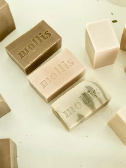A peek into my daily soap cutting table, with freshly cut and stamped bars in earthy, neutral tones.