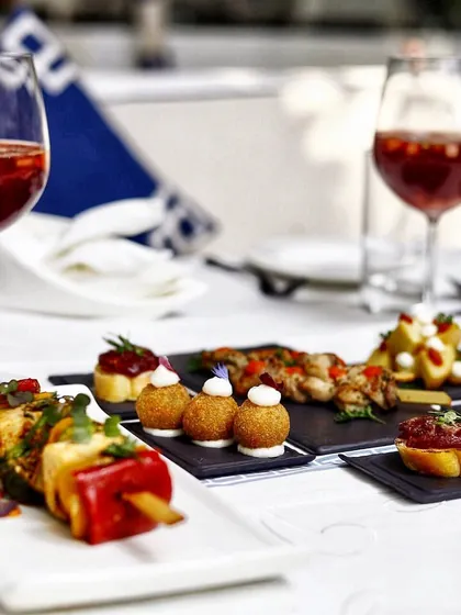 A variety of our tapas served on slate and wooden boards, ready for sharing. The presentation is rustic yet elegant, just like the food.