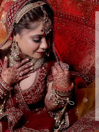 An album page featuring a dramatic shot of the bride in her red lehenga, paired with a photo of the couple.