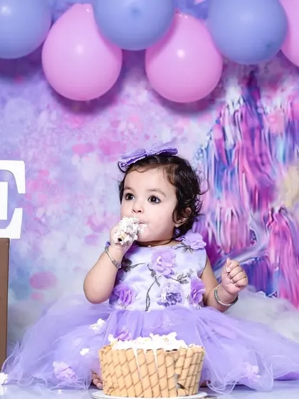 Even fairies love cake. Here, Mahira is enjoying a little treat during her first birthday fairy-themed photoshoot.
