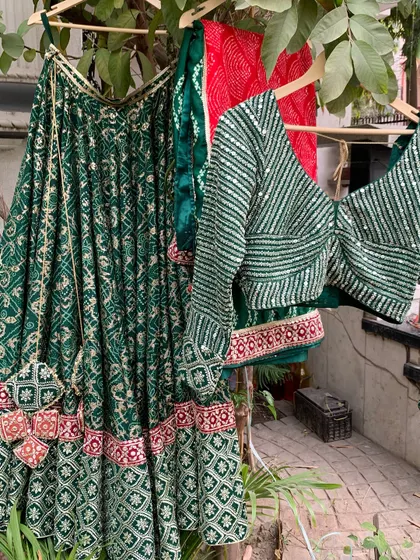 The lehenga, blouse, and dupatta hanging together, a perfect trio.