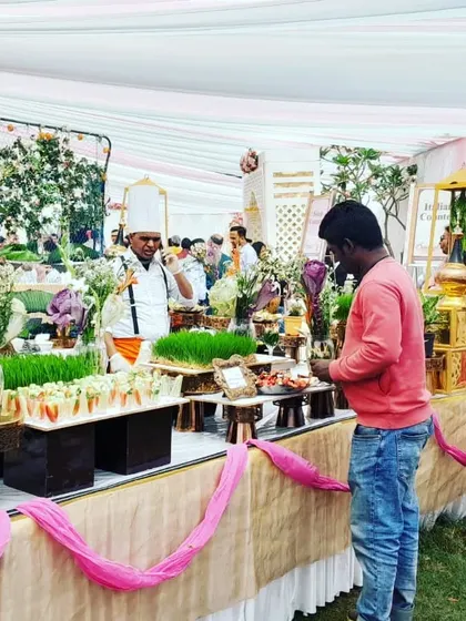 A guest interacting with one of my chefs at a salad counter, highlighting the interactive and service-oriented nature of my catering.