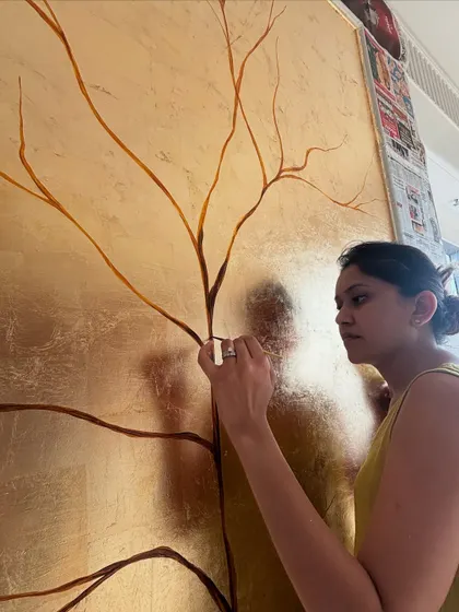 A candid shot of me, completely focused on painting the fine branches of the tree. This kind of detailed work requires a steady hand and lots of concentration.