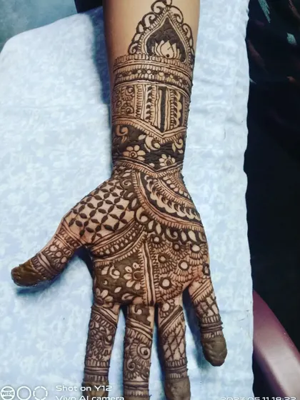 A close-up of one hand from the previous set, showing the detail in the dome motif and the surrounding patterns.