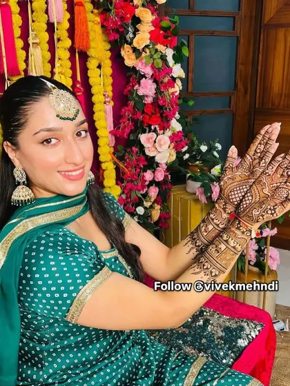 A beautiful client at her engagement ceremony. Her mehndi is detailed yet elegant, perfectly complementing her traditional attire.
