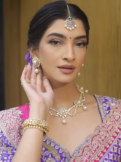 A soft and regal makeup look that radiates timeless elegance. Paired with a royal purple and pink saree, this look is perfect for a wedding guest or a festive occasion.