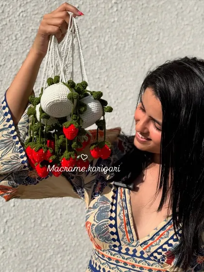 Our hanging strawberry pot charm is a unique decoration for your car or home. It features a little white pot with bright red strawberries dangling down, all handmade from crochet.