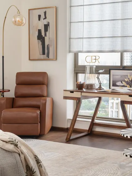 A dedicated reading and work corner within the master bedroom. I designed this space with a comfortable recliner and a sleek wooden desk to provide a functional yet stylish area for productivity and relaxation, proving that every corner can serve a purpose.