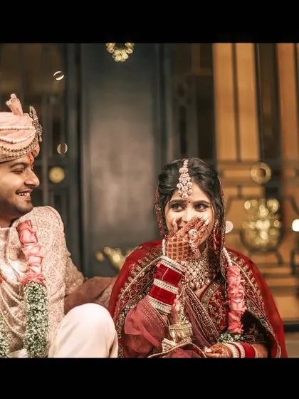 A candid shot of the bride's reaction during the joota churai rasam, a moment of pure fun.