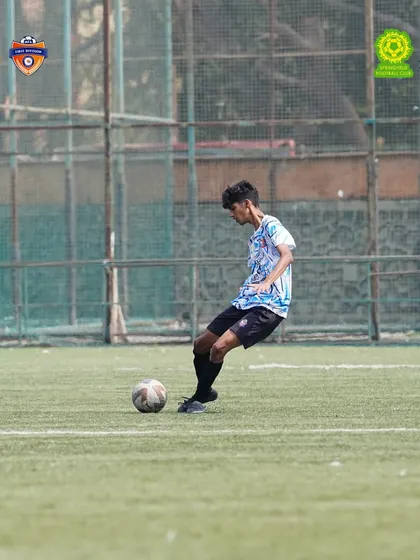 Setting up the attack. A player prepares to make a decisive pass during the game. Our training emphasizes quick decision-making and technical precision under pressure.