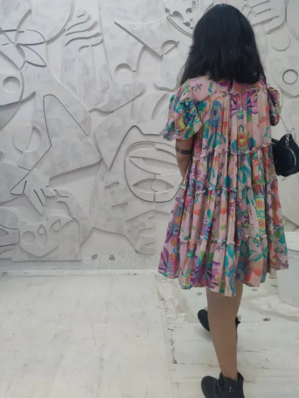 To show the monumental scale of our work, this image captures a person standing beside a large, abstract 3D wall mural. Made from plaster, the piece is a 'cosmic tapestry' of layered shapes and lines, transforming a simple wall into a landscape of myth and memory.