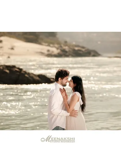 A tender pre-wedding portrait on the banks of the Ganga, with the sparkling water creating a beautiful, natural backdrop. The soft light and close embrace make this a truly romantic shot.