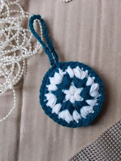 A mandala-style Christmas ornament. A unique, bohemian take on holiday decor.